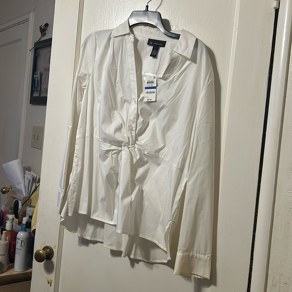It is long sleeve cotton and buttons down front.